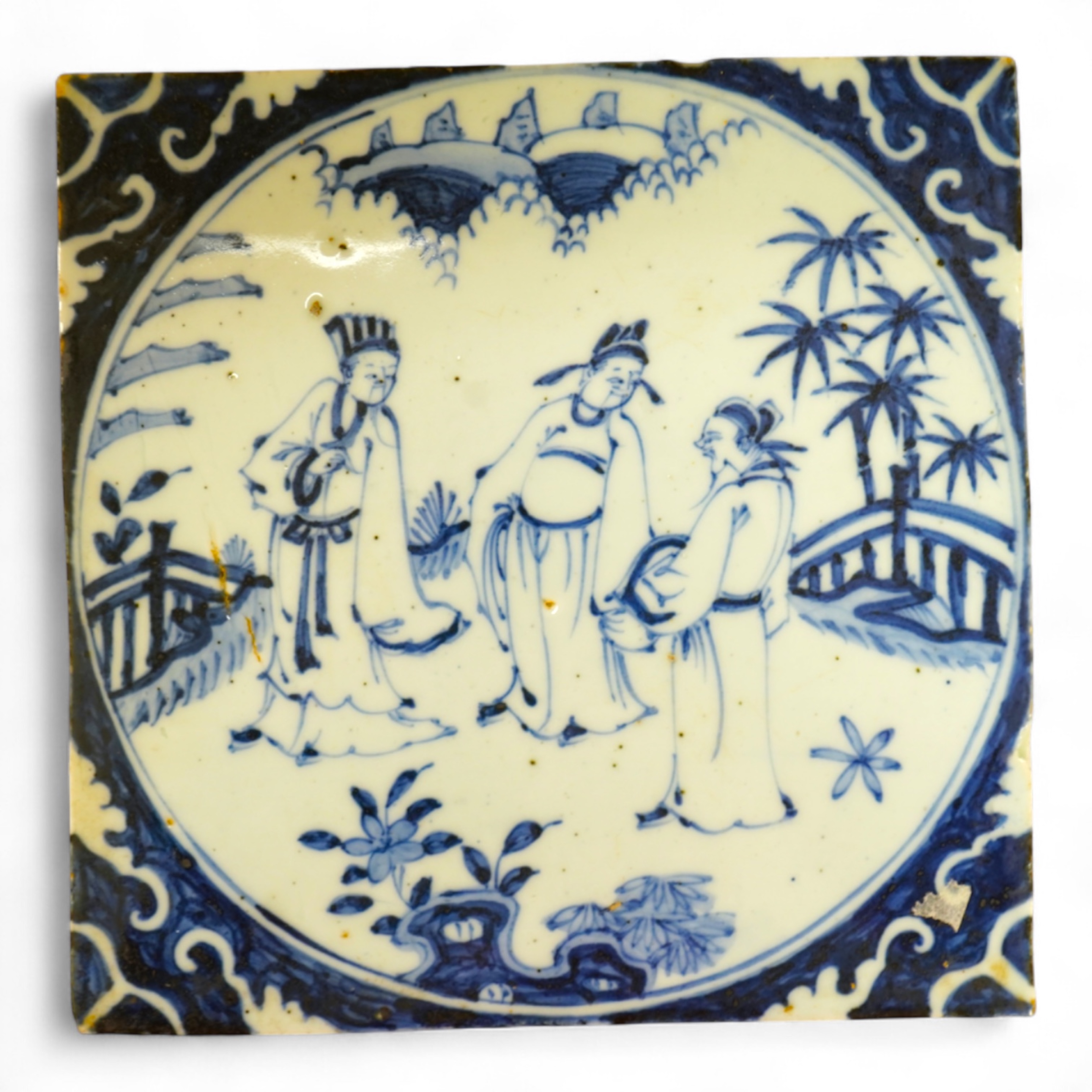 A Chinese tile depicting three figures, 20cm wide